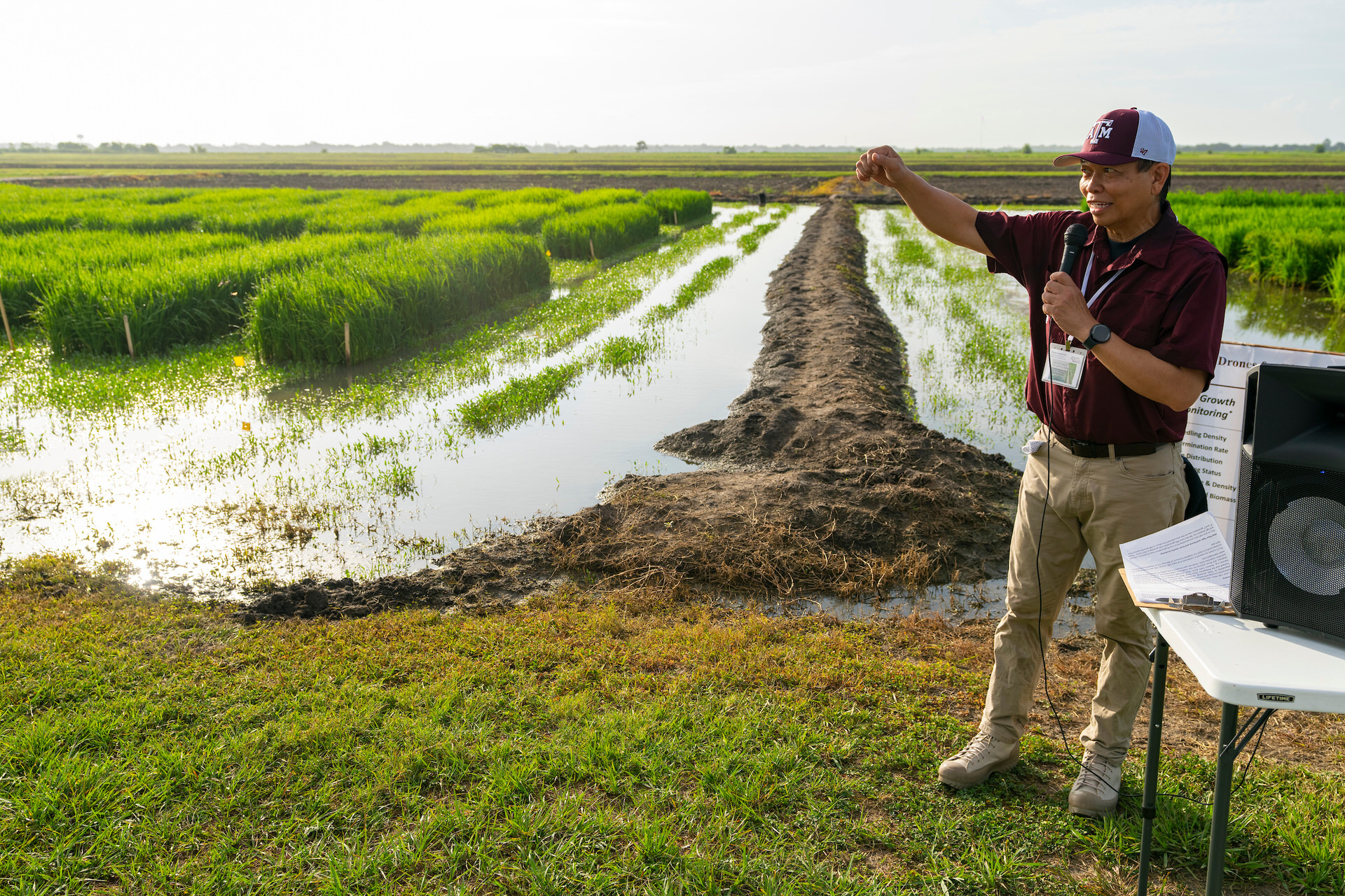 person standing in flooded field giving a speech