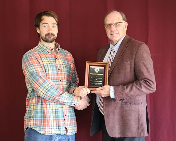 William Wheeler standing with David Baltensperger, professor and department head.