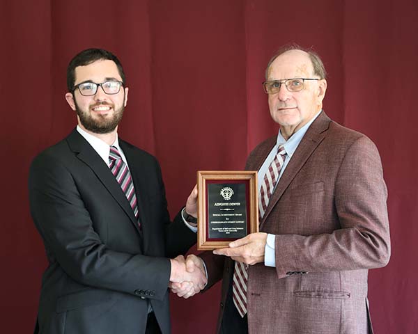 Aenghus Denvior standing with David Baltensperger, professor and department head.