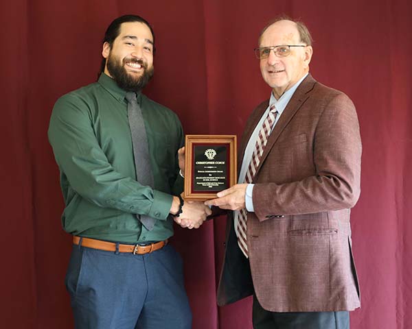 Chris Cobos standing with David Baltensperger, professor and department head.