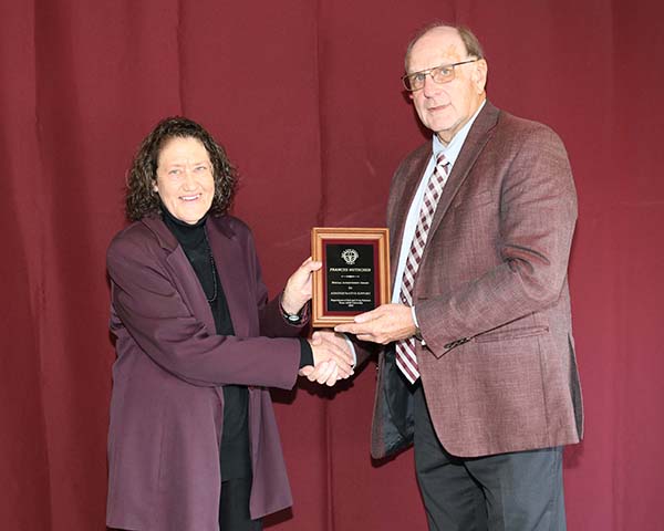 Frances Mutscher standing with David Baltensperger, professor and department head.