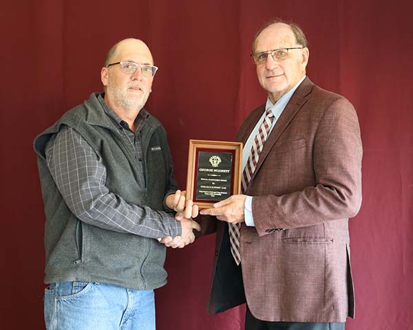 George Hodnett standing with David Baltensperger, professor and department head.