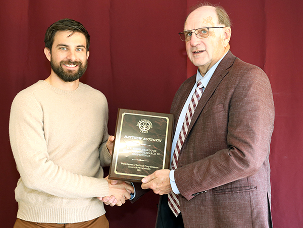 Matthew Kutugata standing with David Baltensperger, professor and department head.