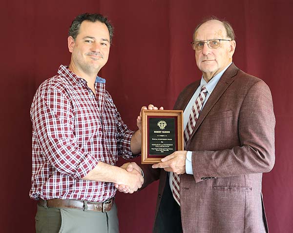 Robert Vaughn standing with David Baltensperger, professor and department head.
