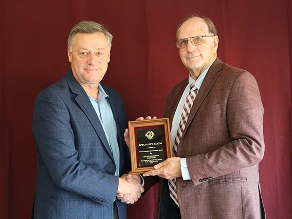Ted Fist standing with David Baltensperger, professor and department head.