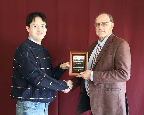 Sungkyu Park standing with David Baltensperger, professor and department head.