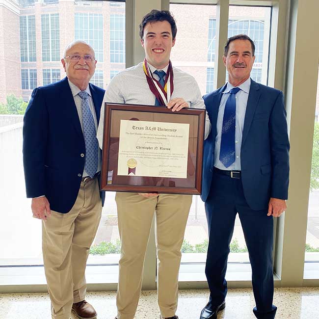 Chris Barron, center, stands with Jeffrey W. Savell, Ph.D., vice chancellor and dean for Agriculture and Life Sciences, left, and David Stelly, Ph.D., right.